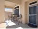 Relaxing covered front patio with a table and chairs, offering a cozy outdoor seating area at 3336 E Thornton Ave, Gilbert, AZ 85297