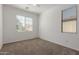 Bedroom featuring neutral carpet and two windows offering natural light at 3467 S Falcon Dr, Gilbert, AZ 85297