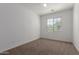 Bedroom with carpet, ceiling fan, and one window for natural light at 3467 S Falcon Dr, Gilbert, AZ 85297