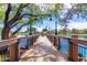 Community pier surrounded by black, metal railing, street lamps, and a view of a stunning, still lake at 3467 S Falcon Dr, Gilbert, AZ 85297