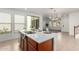 Stylish kitchen island with sink, seating and view of backyard and open concept living space at 3467 S Falcon Dr, Gilbert, AZ 85297