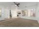 Spacious living room featuring neutral carpet, large windows, and an open layout with great natural light at 3467 S Falcon Dr, Gilbert, AZ 85297