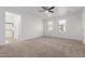 Spacious main bedroom with carpet, ceiling fan, walk-in shower and two windows for natural light at 3467 S Falcon Dr, Gilbert, AZ 85297