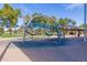 Community playground featuring playground equipment, soft ground cover, and shaded picnic tables at 3467 S Falcon Dr, Gilbert, AZ 85297