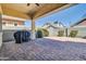 Cozy covered patio with brick pavers, barbecue, and view of a neighboring house at 4342 E Ronald St, Gilbert, AZ 85295