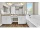 Bathroom with double vanity sinks, granite countertop, mirror, and a bathtub at 4342 E Ronald St, Gilbert, AZ 85295