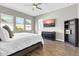 Tranquil bedroom with calming colors, wood-look tile, TV, and bright windows at 4342 E Ronald St, Gilbert, AZ 85295