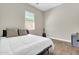 Minimalist bedroom features wood-look tile flooring and plenty of natural light at 4342 E Ronald St, Gilbert, AZ 85295