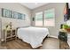 Comfortable bedroom with accent wall art, windows with blinds, and a ceiling fan at 4342 E Ronald St, Gilbert, AZ 85295