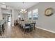 Dining room with a chandelier, hardwood floors and several windows providing great natural light at 4342 E Ronald St, Gilbert, AZ 85295