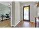 Home's entryway showcasing a decorative iron door, chandelier, and wood floors at 4342 E Ronald St, Gilbert, AZ 85295