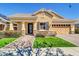 Charming single-story home with a well-manicured lawn, covered porch and a tandem 3-car garage at 4342 E Ronald St, Gilbert, AZ 85295