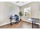 Spacious home office with natural light, a dark desk, rolling chair, and neutral decor at 4342 E Ronald St, Gilbert, AZ 85295