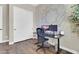 Functional home office featuring a dark desk, rolling chair, and sliding closet doors at 4342 E Ronald St, Gilbert, AZ 85295