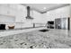 Close up of kitchen island with white cabinets, a sink and granite countertops at 4342 E Ronald St, Gilbert, AZ 85295