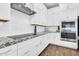 Modern kitchen featuring white subway tile backsplash, stone counter and stainless vent hood at 4342 E Ronald St, Gilbert, AZ 85295