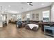 Open-concept living area features wood-look tile floors, large windows, and neutral color palette at 4342 E Ronald St, Gilbert, AZ 85295