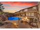 Stunning backyard with a pool, rock waterfall, and cozy fire pit with seating area at 45539 W Long Way, Maricopa, AZ 85139