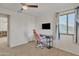Bedroom with light carpet, window with natural light and a TV for entertainment at 45539 W Long Way, Maricopa, AZ 85139