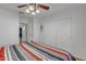 Bright bedroom features a ceiling fan and closet for ample storage space at 45539 W Long Way, Maricopa, AZ 85139