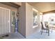 Cozy covered front porch with seating area and 'Welcome' sign at 45539 W Long Way, Maricopa, AZ 85139