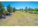 An expansive green space with mature trees lining the edges, offering a serene and open area for recreation at 45539 W Long Way, Maricopa, AZ 85139