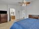 Comfortable main bedroom featuring a ceiling fan, ensuite bathroom and soft natural light at 45539 W Long Way, Maricopa, AZ 85139