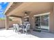 Covered outdoor patio with ceiling fan and dining area at 45539 W Long Way, Maricopa, AZ 85139