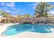 Backyard pool with a rock waterfall slide and ample lounge space at 45539 W Long Way, Maricopa, AZ 85139
