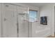 Shower featuring a glass door next to a bathtub with a window with natural light at 45539 W Long Way, Maricopa, AZ 85139