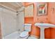 Bright bathroom with a tiled shower and pedestal sink at 4705 E Winston Dr, Phoenix, AZ 85044