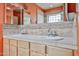 Bathroom featuring dual sinks with light-colored cabinets and neutral tiled walls at 4705 E Winston Dr, Phoenix, AZ 85044