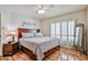 Bedroom with hardwood floors, a ceiling fan, and shuttered doors to let in natural light at 4705 E Winston Dr, Phoenix, AZ 85044