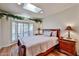 Bedroom with a queen-sized bed, bay window, and wood floors at 4705 E Winston Dr, Phoenix, AZ 85044