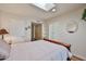 Bright bedroom featuring hardwood floors, a skylight, shutters, and ample closet space at 4705 E Winston Dr, Phoenix, AZ 85044