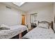 Bedroom with twin beds, mirrored closet, and access to another room at 4705 E Winston Dr, Phoenix, AZ 85044