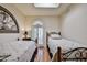 Twin beds in a bedroom with light walls and a window with shutters at 4705 E Winston Dr, Phoenix, AZ 85044