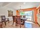 A bright dining room features a wood table and chairs next to a large window at 4705 E Winston Dr, Phoenix, AZ 85044