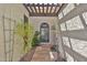 Charming walkway to the front door with a pergola, desert landscaping and travertine pavers at 4705 E Winston Dr, Phoenix, AZ 85044