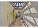 Charming walkway to the front door with a pergola, desert landscaping and travertine pavers at 4705 E Winston Dr, Phoenix, AZ 85044