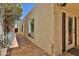Exterior view of house with stucco wall, glass window, stone pavers, and desert vegetation at 4705 E Winston Dr, Phoenix, AZ 85044
