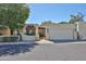 Charming front exterior with stucco and tile details, attached garage, and desert landscaping at 4705 E Winston Dr, Phoenix, AZ 85044