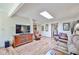Spacious living room with skylight, wood floors, and a built-in entertainment center at 4705 E Winston Dr, Phoenix, AZ 85044