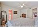 Cozy main bedroom featuring neutral walls, wood floors, ceiling fan, and ensuite bath access at 4705 E Winston Dr, Phoenix, AZ 85044
