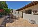 Rear patio area with stone pavers, shade and desert landscaping at 4705 E Winston Dr, Phoenix, AZ 85044