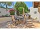 Charming outdoor patio featuring stone pavers, lush garden beds and a table with seating at 4705 E Winston Dr, Phoenix, AZ 85044
