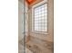 Stylish shower featuring neutral tiled walls, a glass block window, and tiled floors at 4705 E Winston Dr, Phoenix, AZ 85044