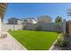 Spacious backyard featuring artificial turf, block wall, and low-maintenance landscaping at 4832 S Ferric --, Mesa, AZ 85212