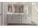 Bathroom featuring a double sink vanity, large mirror, and glass-enclosed shower at 4832 S Ferric --, Mesa, AZ 85212