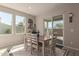 Inviting dining room with a rustic table, bright windows, and a view of the outdoor patio at 4832 S Ferric --, Mesa, AZ 85212